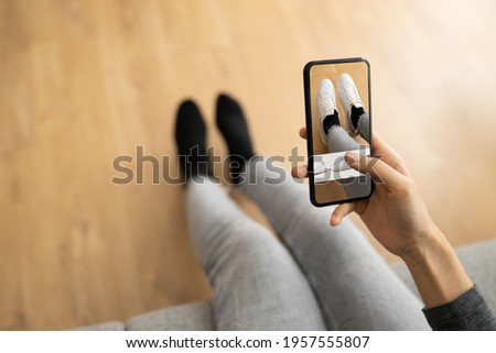 Woman Trying Virtual Sneakers In Shop Or Store AR App Foto stock © 