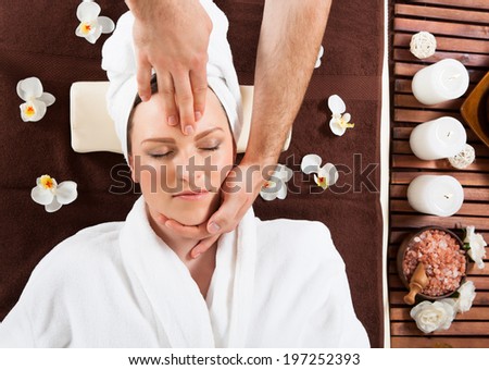 Directly above shot of young woman receiving head massage at beauty spa