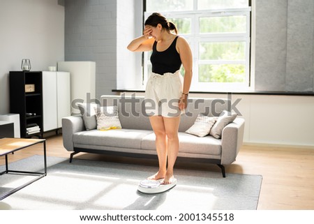 Sad Woman On Weight Scale After Diet Checking Foto d'archivio © 