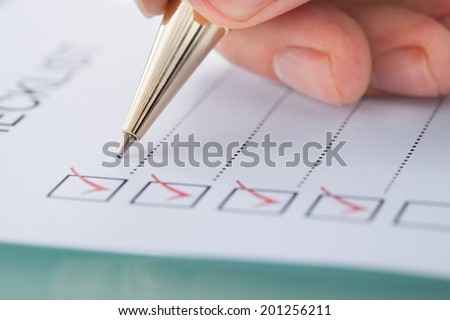 Cropped image of businessman preparing checklist at office desk ストックフォト © 