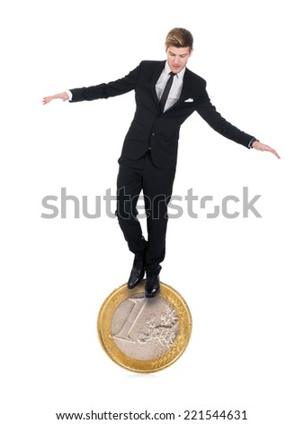 Full length of young businessman balancing on one euro coin over white background