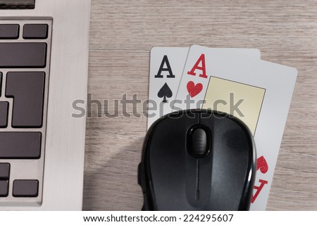 Playing cards and computer in online gaming concept