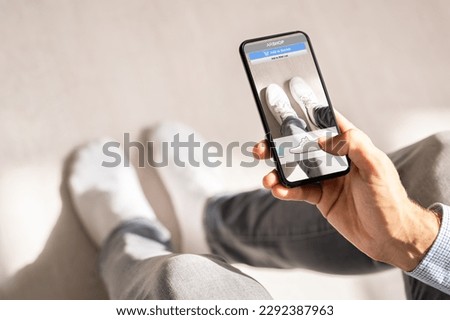 Man Trying Virtual Sneakers In Shop Or Store AR App Foto stock © 
