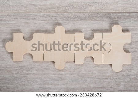 Directly above shot of wooden jigsaw pieces on table
