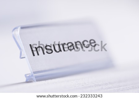 Closeup of Insurance tab on white table