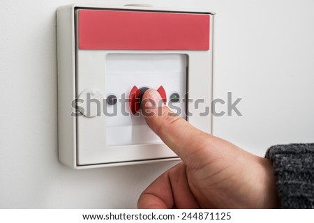 Close-up Of A Person\'s Hand Pressing Emergency Alarm Button