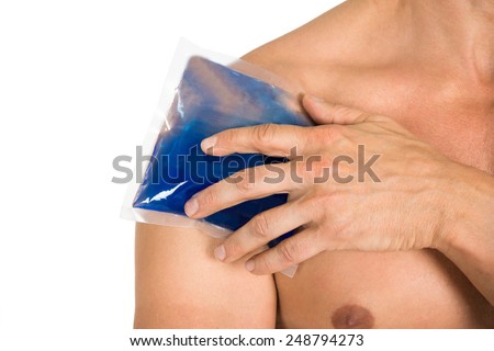 Close-up Of Hand Holding Ice Gel Pack On Shoulder Over White Background