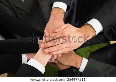 Close-up Of Businesspeople Stacking Hands On Top Of Each Other