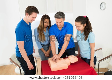 Health Class Instructor Demonstrates Cpr Life Saving Techniques To Students