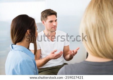 Group Of Young People Having Conversation