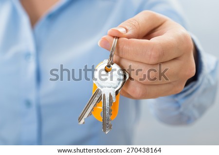 Close-up Of Businessperson Hand Holding Key In Hand