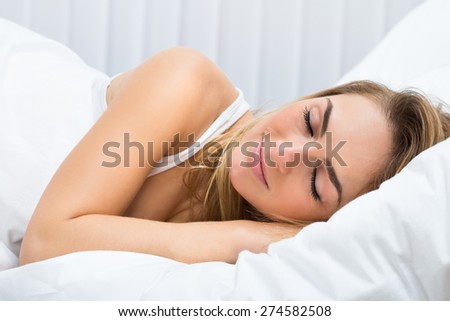 Close-up Of Beautiful Young Woman Sleeping On Bed
