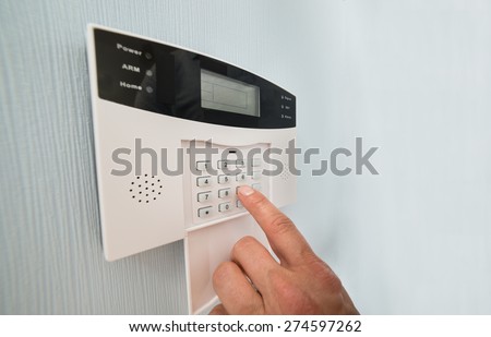 Close-up Of A Person\'s Hand Entering Code In Security System