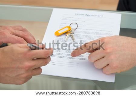 Close-up Of A Person Signing Lease Agreement