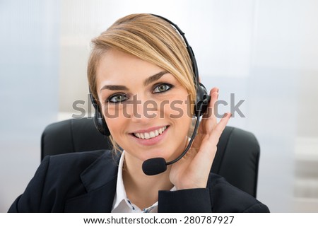Close-up Of Smiling Female Customer Service Representative With Microphone