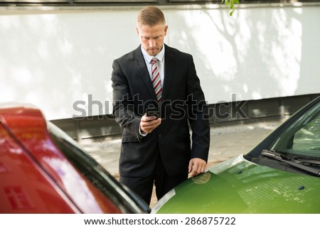 Man Photographing His Vehicle With Damages For Accident Insurance
