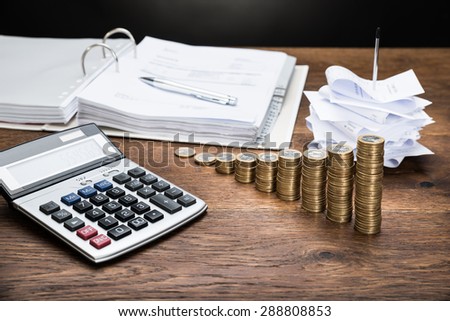 Receipts In Paper Nail With Calculator And Money On Desk
