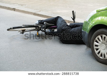 Unconscious Male Cyclist Lying On Road After Road Accident