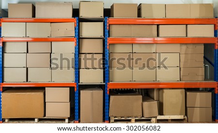 Cardboard Boxes On Shelves In Distribution Warehouse