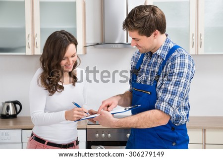Similar – Image, Stock Photo Plumber signs a contract for the services in the kitchen