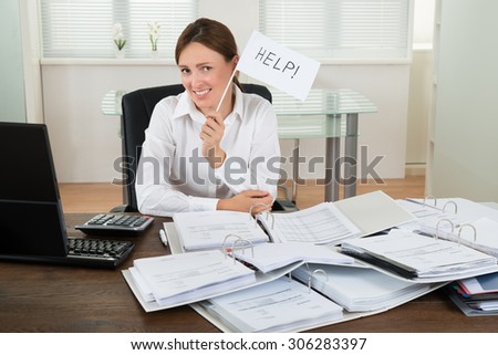 Young Businesswoman With Invoices Asking For Help At Desk