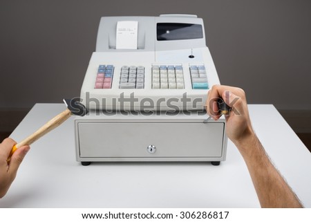 Close-up Of Person Hands Trying To Open Cash Register Drawer With Worktool