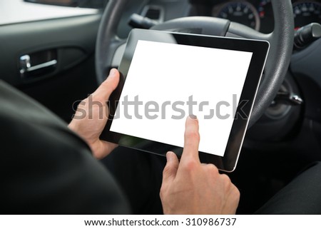 Close-up Of A Businessman Sitting In Car Holding Digital Tablet With Blank Screen