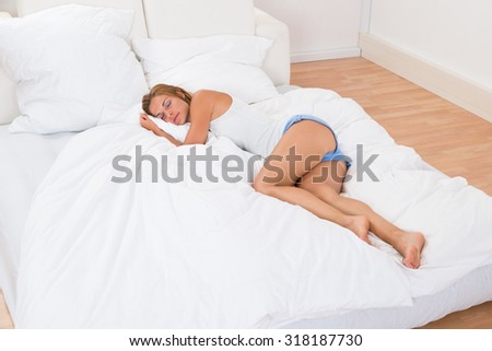 Young Beautiful Woman Sleeping In Bed At Home