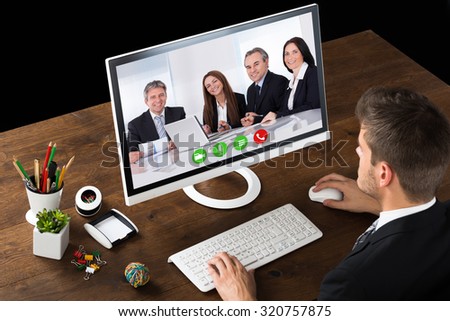 Young Businessman Online Videochatting With Colleagues On Computer