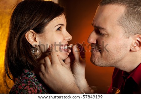 Men taking care of girlfriend\'s teeth. Focus on the girls eye