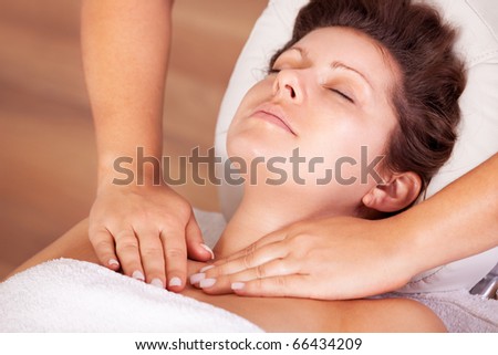 Young beautiful woman getting shoulders massage. Spa studio shot