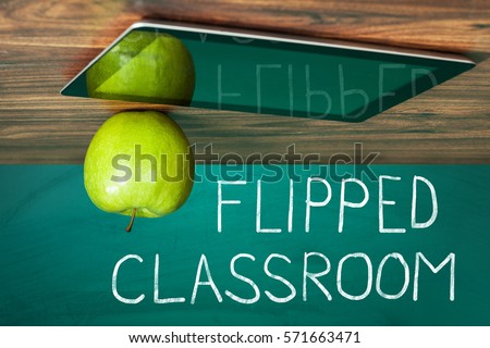 Flipped Classroom Concept On Blackboard With Apple And Digital Tablet On Wooden Table