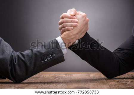Close-up Of Two Businesspeople Competing In Arm Wrestling On Grey Background Stock foto © 