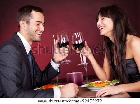 Lovely young couple having romantic dinner in restaurant