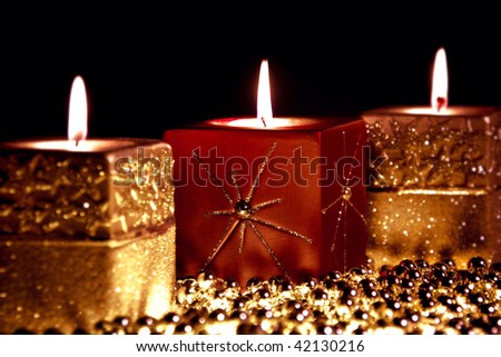 Three candles on black background ,