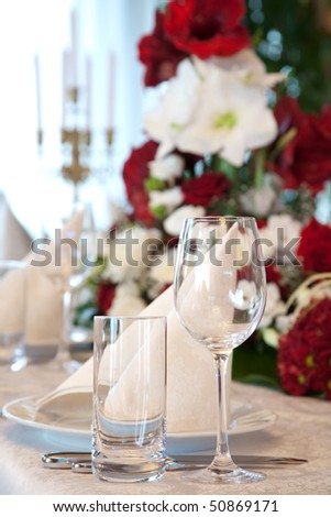 Tables set and salad served for a wedding reception.