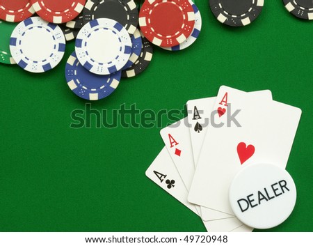 poker hand four aces with chips and dealer button on green felt
