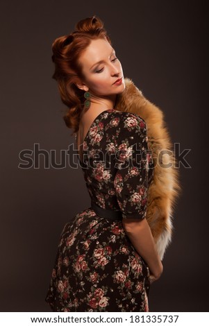 Girl in retro style posing with fur things.