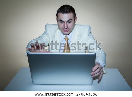 A man in a white suit sitting with a laptop. Makes hand gestures. Vivid emotions.