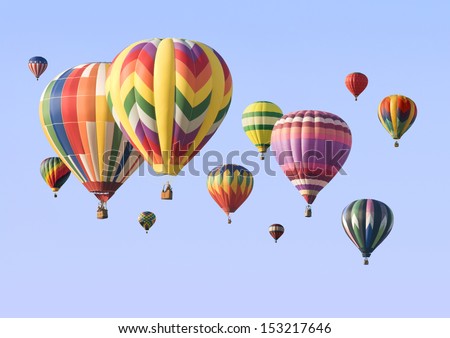 A group of colorful hot-air balloons floating across the sky