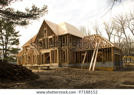 Large McMansion type house under construction in framing phase