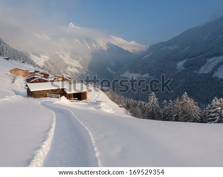 Path through the snow to the mountain village