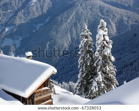 Firewood in the snow-covered log cabin