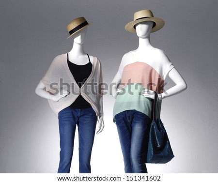 Two Fashion clothes in hat with bag on a mannequin
