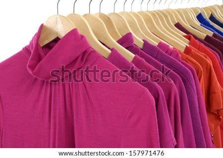 female colorful clothing hanging on hangers