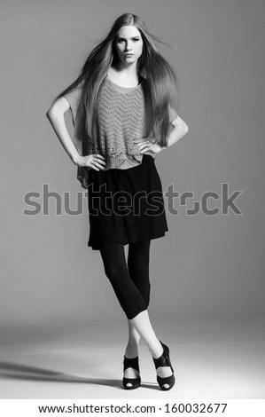 Full length shot of a beautiful woman in high heels in black and white