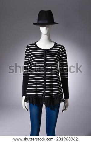 female striped shirt clothing in black hat on mannequin
