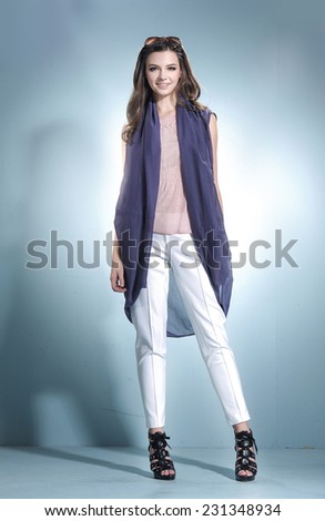 full-length portrait of a styled professional model wearing modern dress in studio
