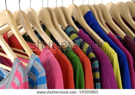 colored Tee Shirts hanging on hangers