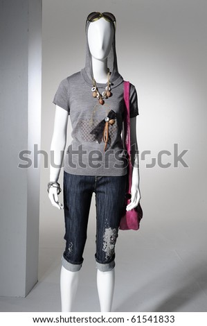 Fashion clothes on a mannequin holding bag
